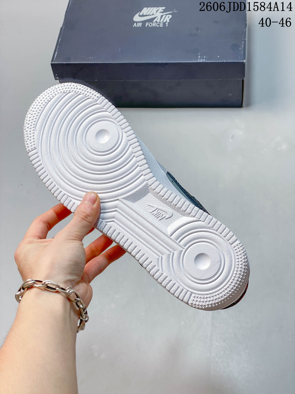 Underside view showing the patterned white outsole of a Nike Air Force 1 sneaker