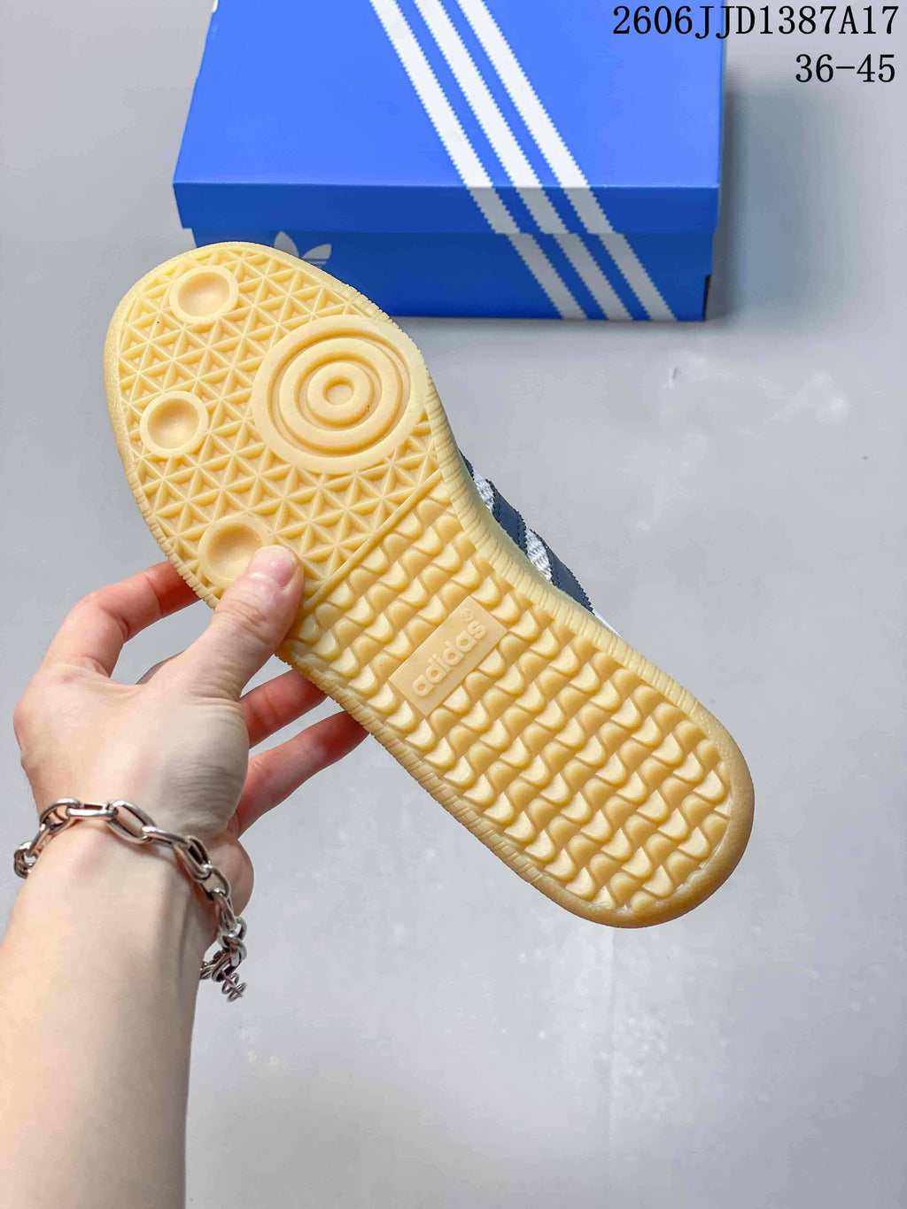 Gum-colored patterned outsole on a white and navy Adidas Samba OG Mule sneaker