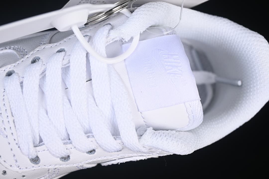 Close-up of the white laces, tongue and padded collar