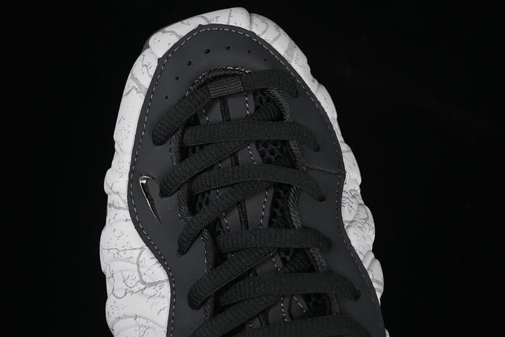 Top-down close-up of black laces and the patterned toe.