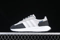 Side view of gray, white, and charcoal adidas Retropy E5 sneakers