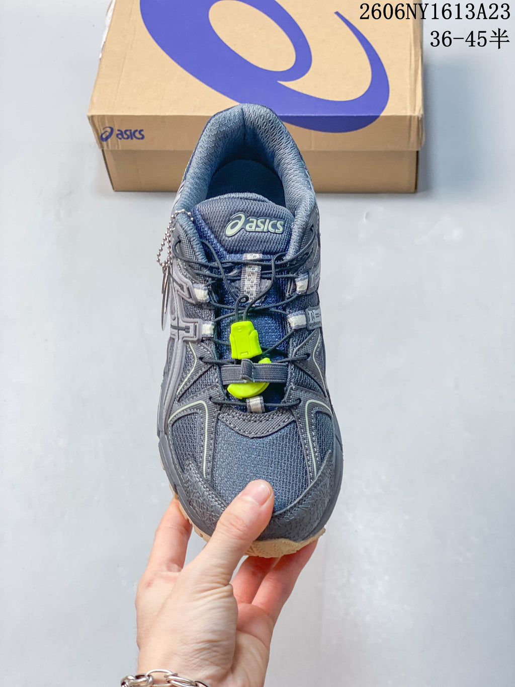 Top view of a grey ASICS Gel-Kahana 8 FL sneaker with lace-up closure and lime details