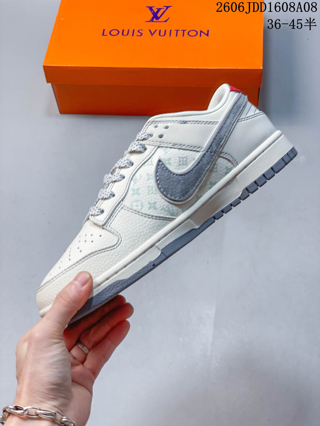 Side view of the cream and gray low-top sneaker with patterned panels
