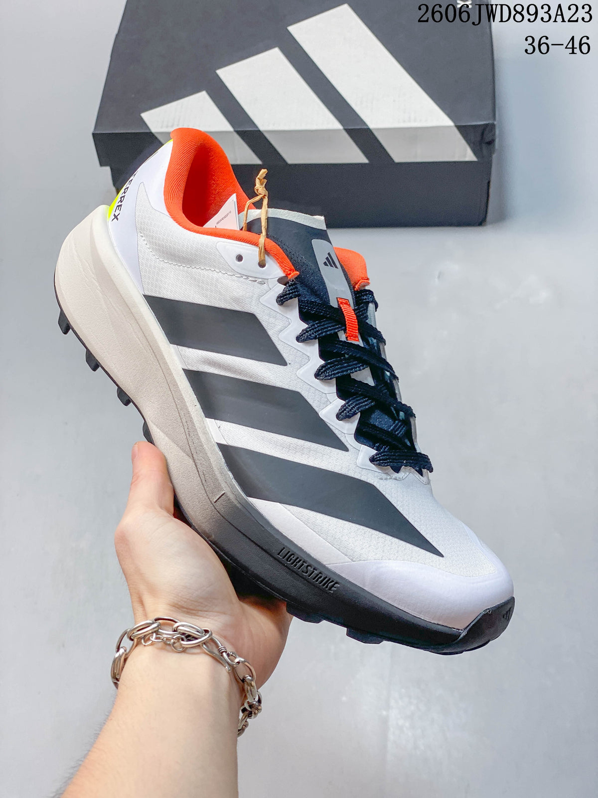 Side view highlighting the white upper, dark gray accents, and lugged outsole.