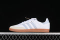 Side view of white adidas Samba OG sneakers with grey stripes, cream toe overlay, and gum sole