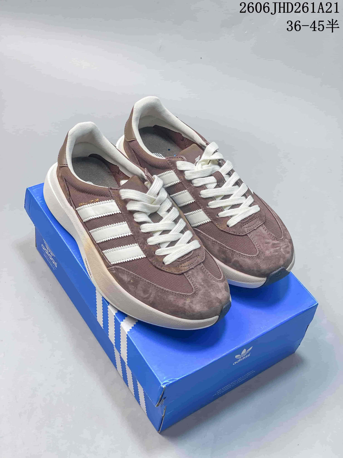 Pair of taupe adidas Originals SL 72 Pro sneakers with white stripes and laces on a blue shoebox