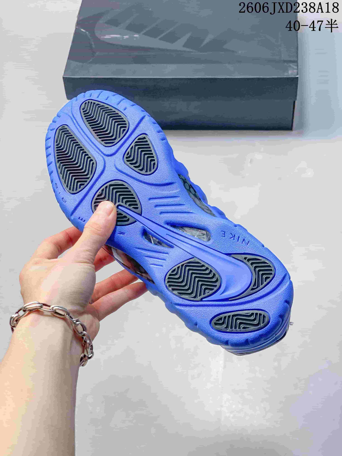 Outsole view showing patterned traction sections on a blue Nike Foamposite Pro shoe