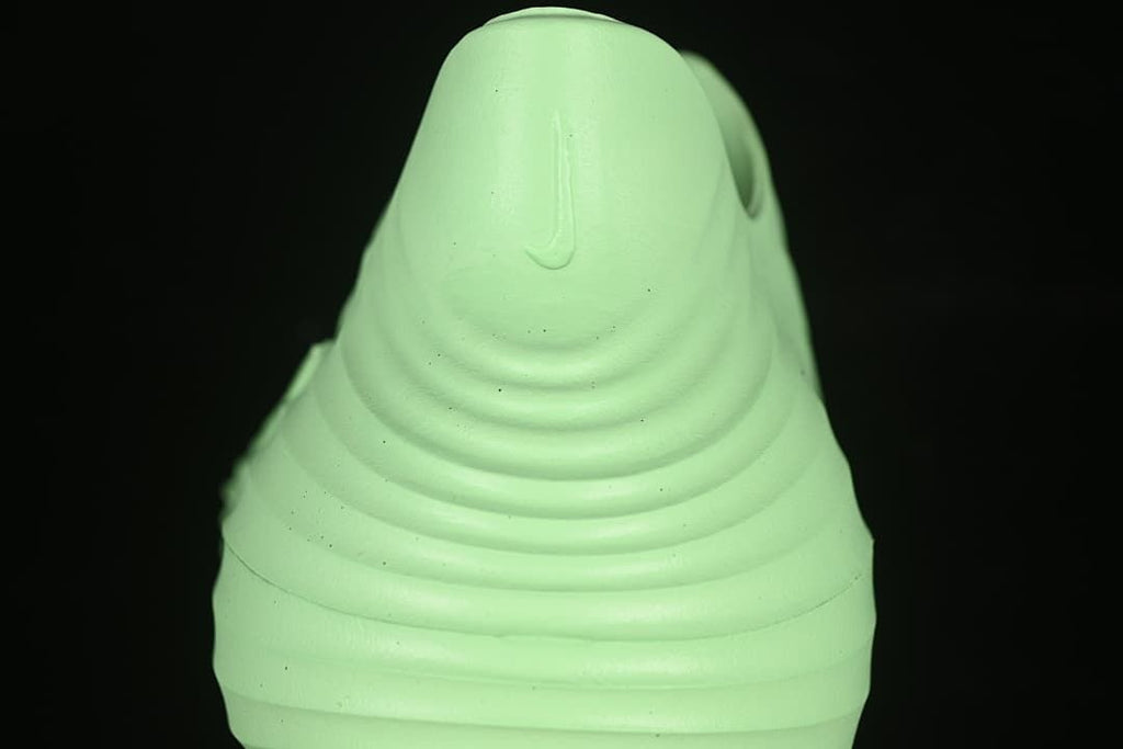 Rear view showing the molded heel of the light green clog