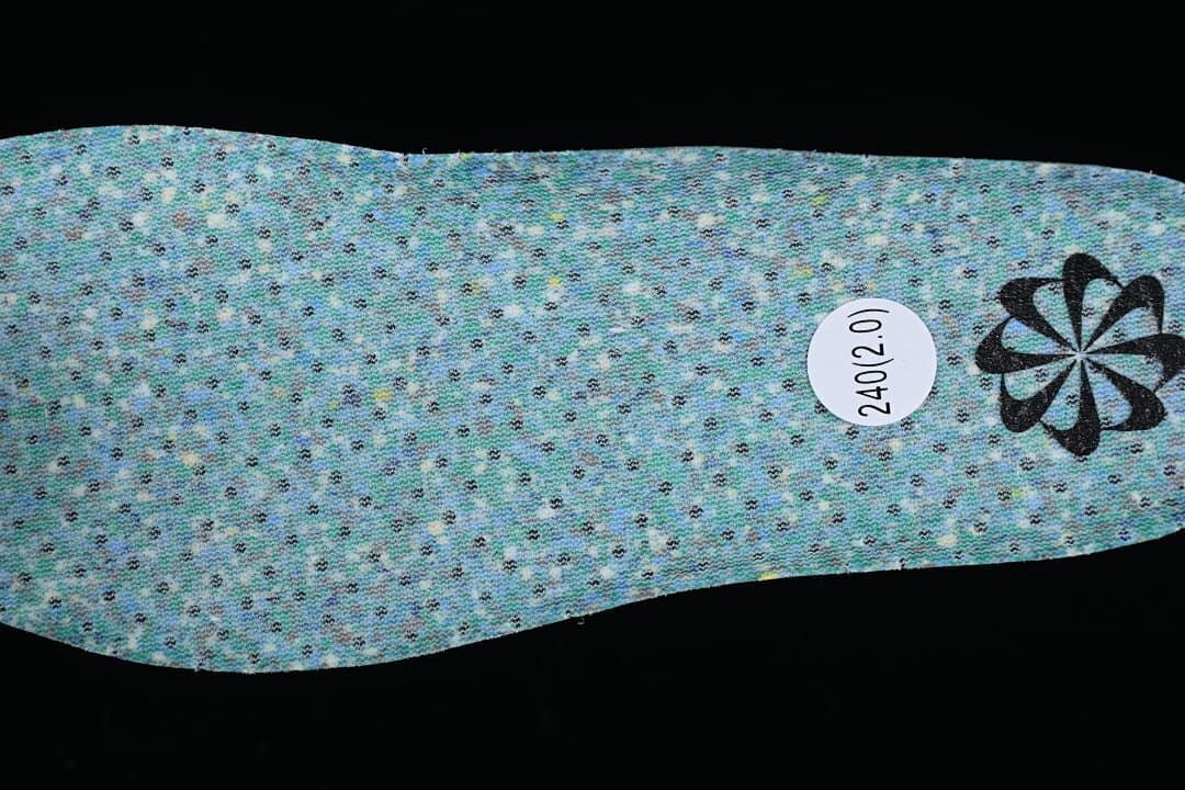 Reverse side of a blue perforated insole with a size marking.