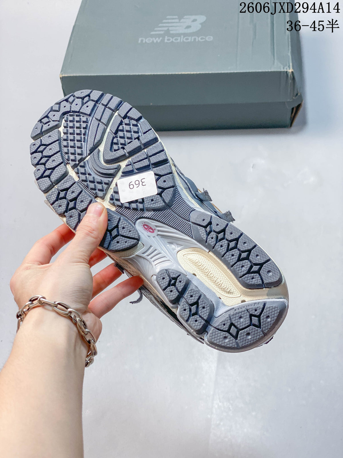 Outsole view of a New Balance 1906 sneaker with a size sticker reading 369