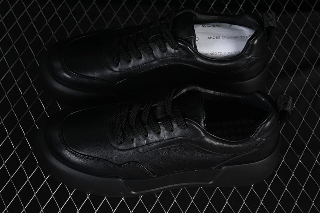 Pair of black sneakers shown from above at an angle
