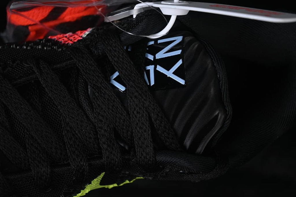 Close-up of the tongue and black laces with Ja-themed lettering.