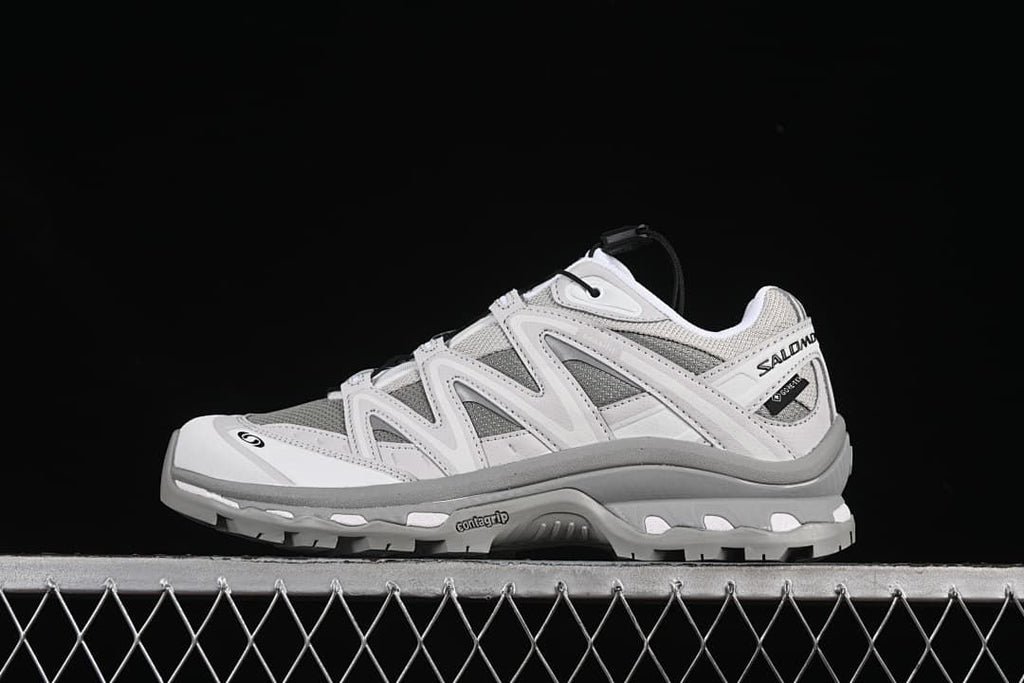 Side view of gray and white Salomon XT-Quest GTX sneakers