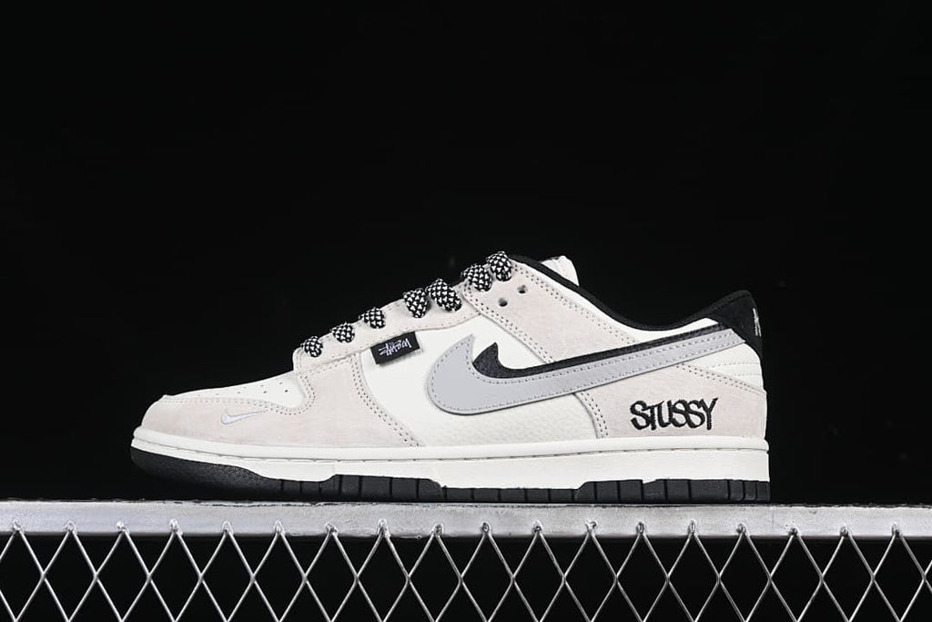 Side profile of the sneaker with Stüssy-style branding