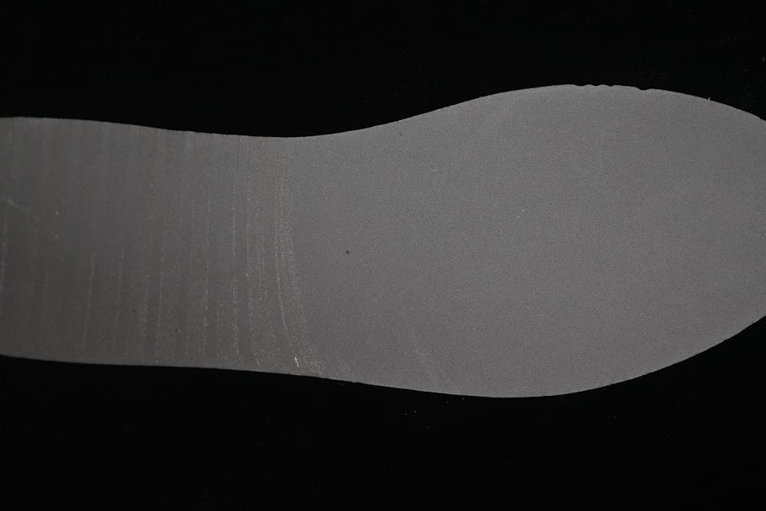 Gray outsole insert photographed against a black background
