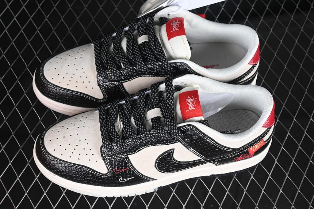 Pair of black and sail low-top sneakers with red accents