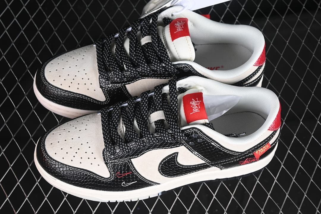 Pair of black and sail low-top sneakers with red accents