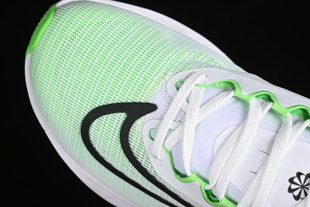 Close-up of the green-and-white mesh upper, black Swoosh, and lacing