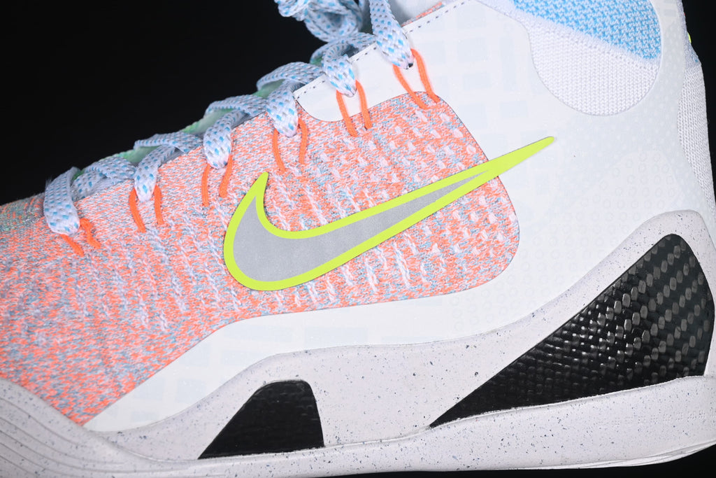 Close-up of the coral upper panel, bright swoosh outline, and midsole.