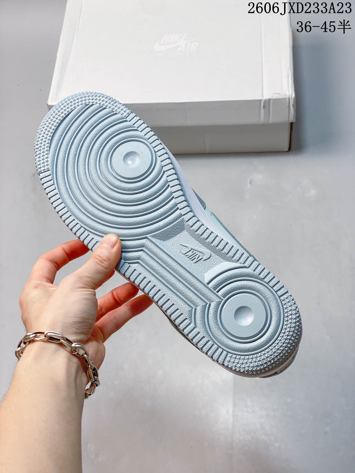 Textured outsole of a pale blue sneaker