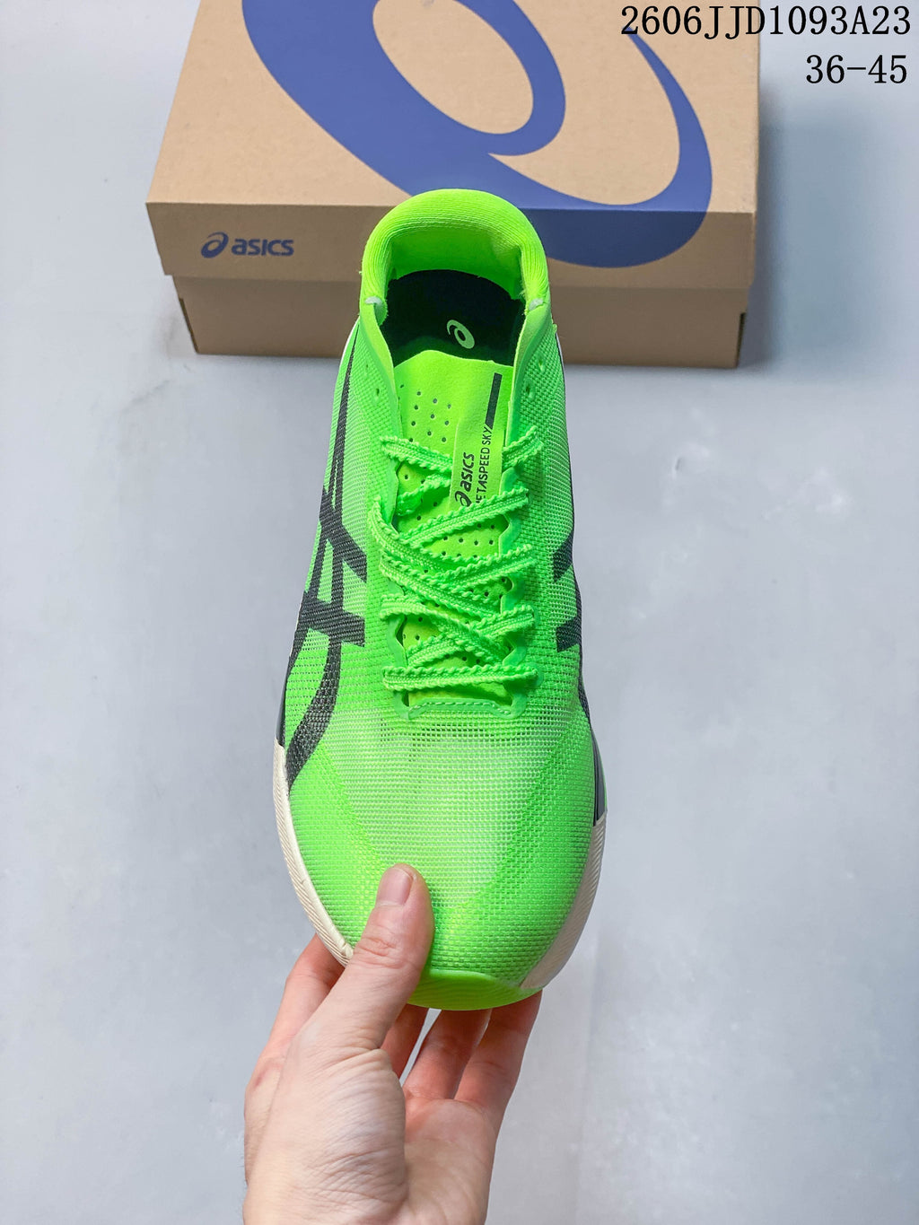 Front view of the bright green running shoe with matching laces