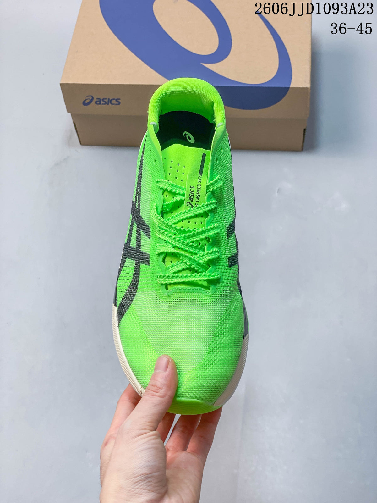 Front view of the bright green running shoe with matching laces