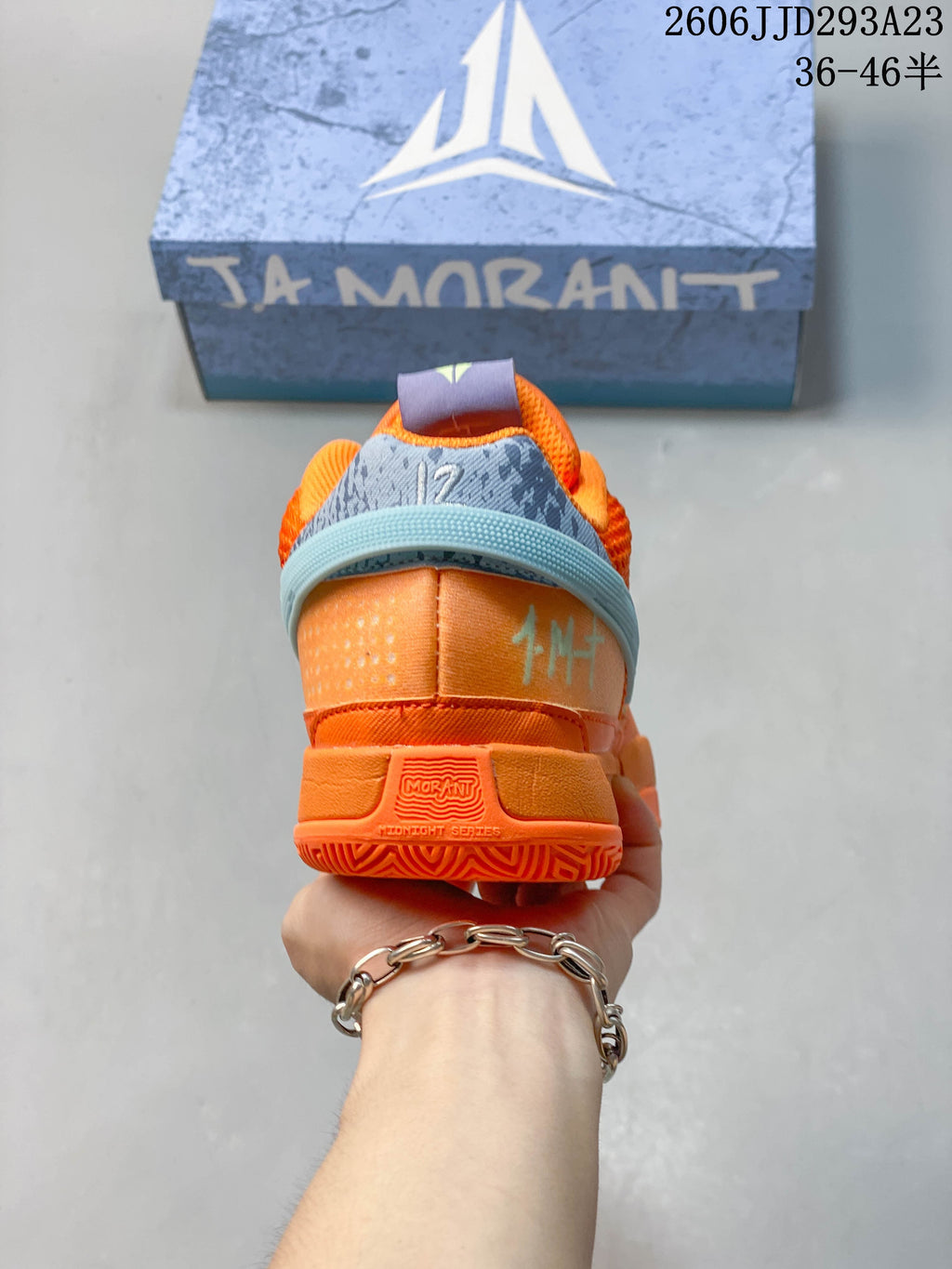 Rear view of the orange shoe showing its heel and collar details.