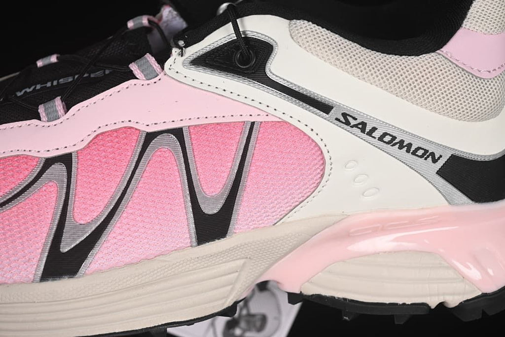 Close-up of the shoe's pink side panels and Salomon branding