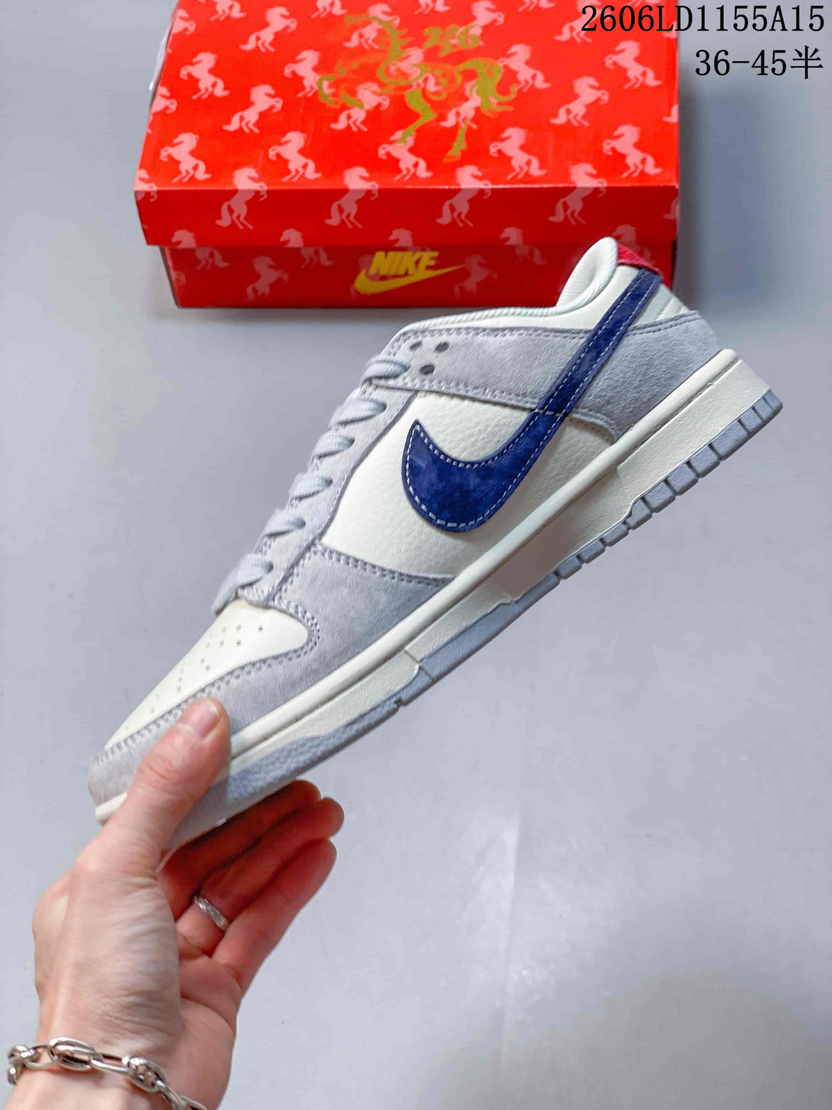 Side profile of the low-top sneaker with a navy Swoosh and grey overlays