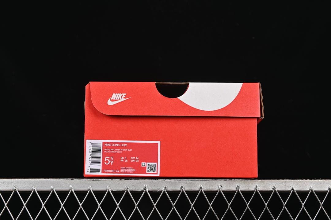 Red Nike shoe box with label identifying Nike Dunk Low and size 5Y