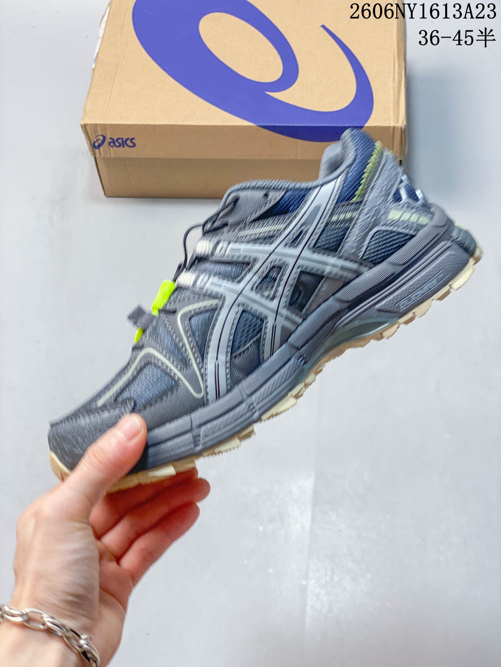 Side profile of a grey ASICS Gel-Kahana 8 FL sneaker with lime accents