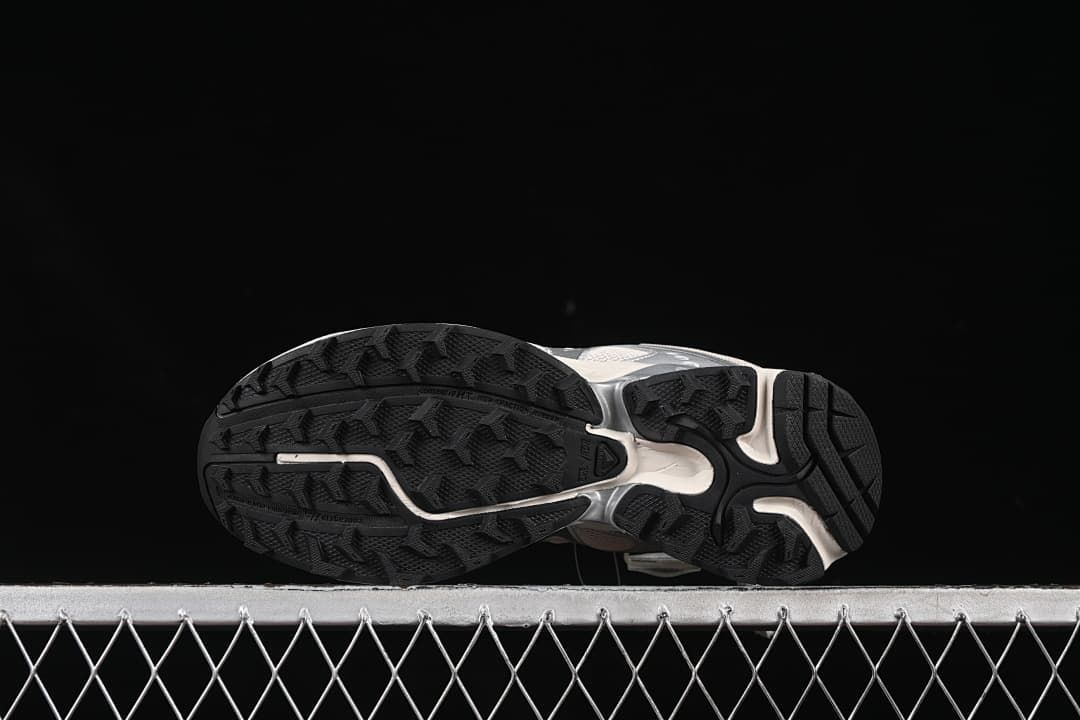 Underside view showing the black patterned outsoles.