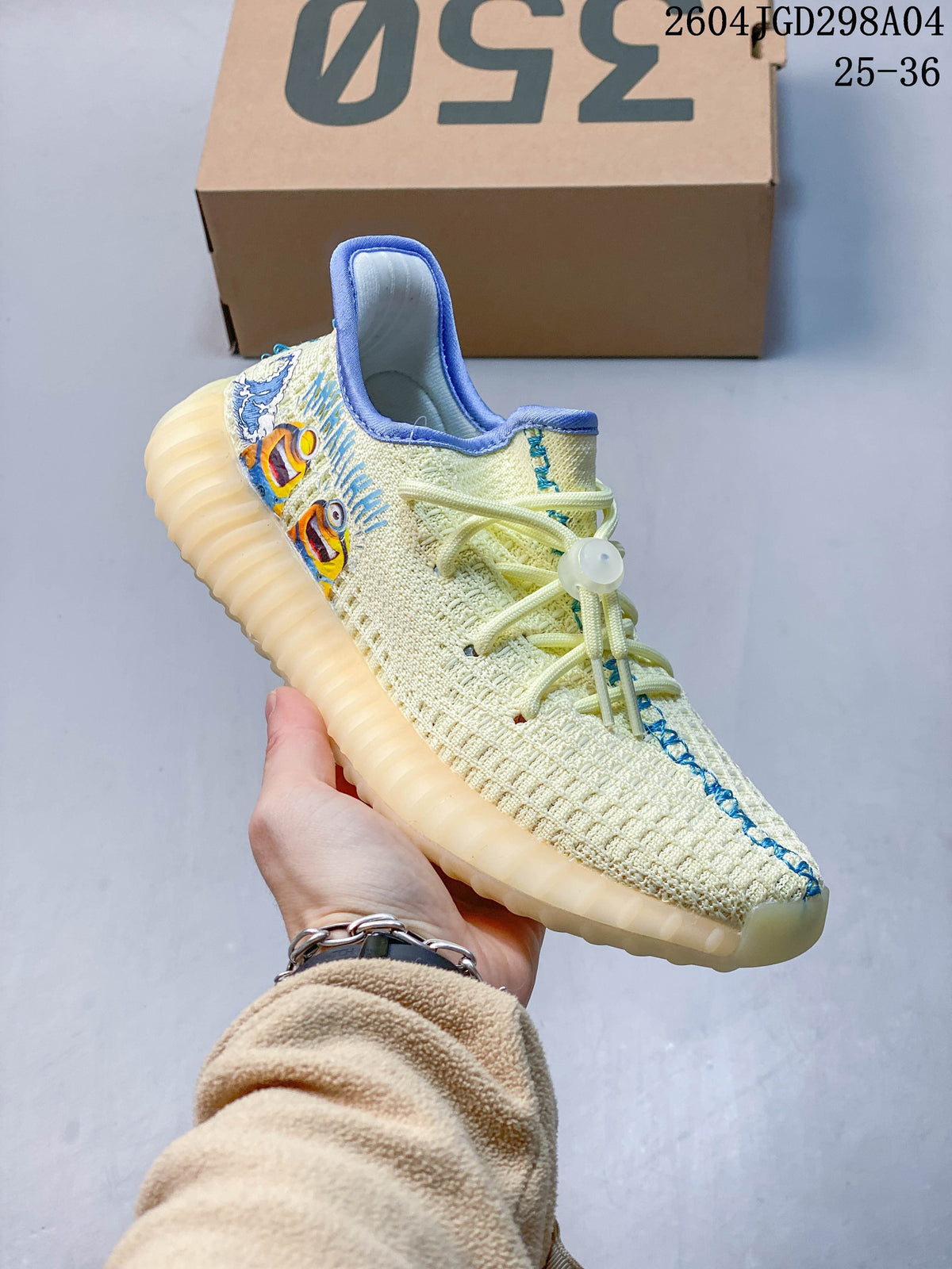 Angled view of a cream Adidas Yeezy 350 V2 sneaker with blue trim and colorful side graphics