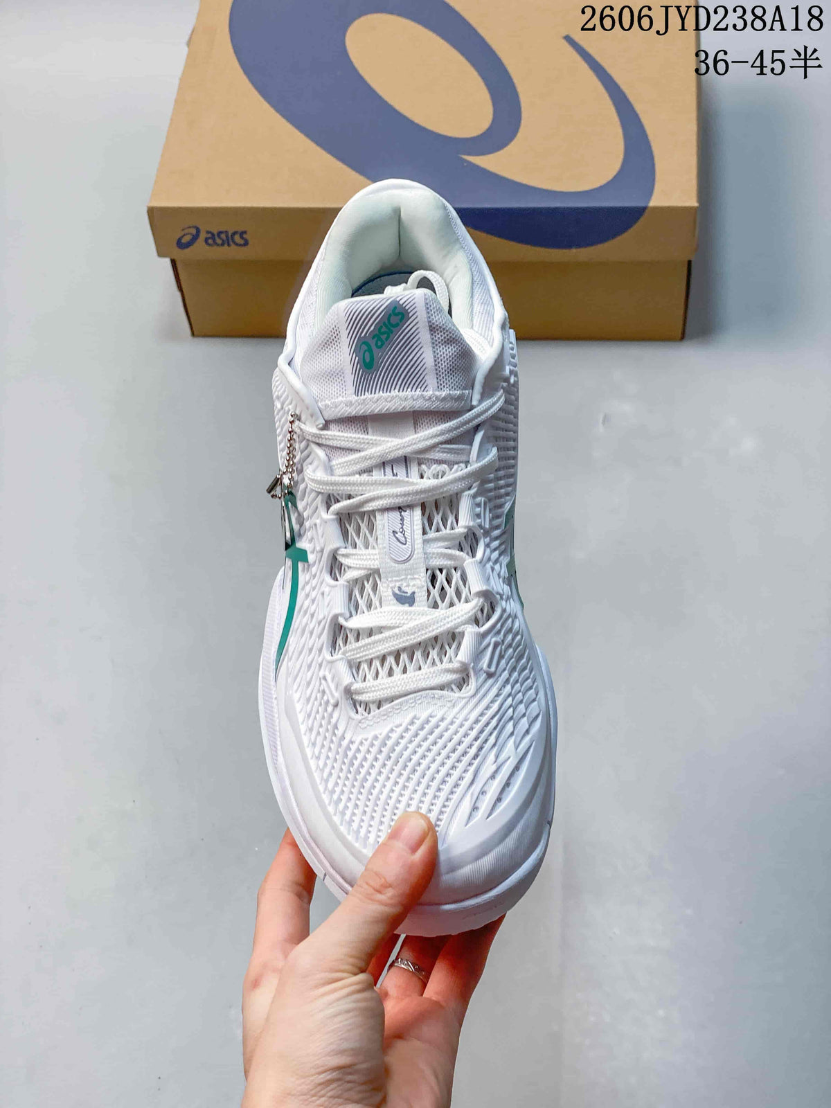 Top view of the white lace-up tennis shoe with mesh-style upper