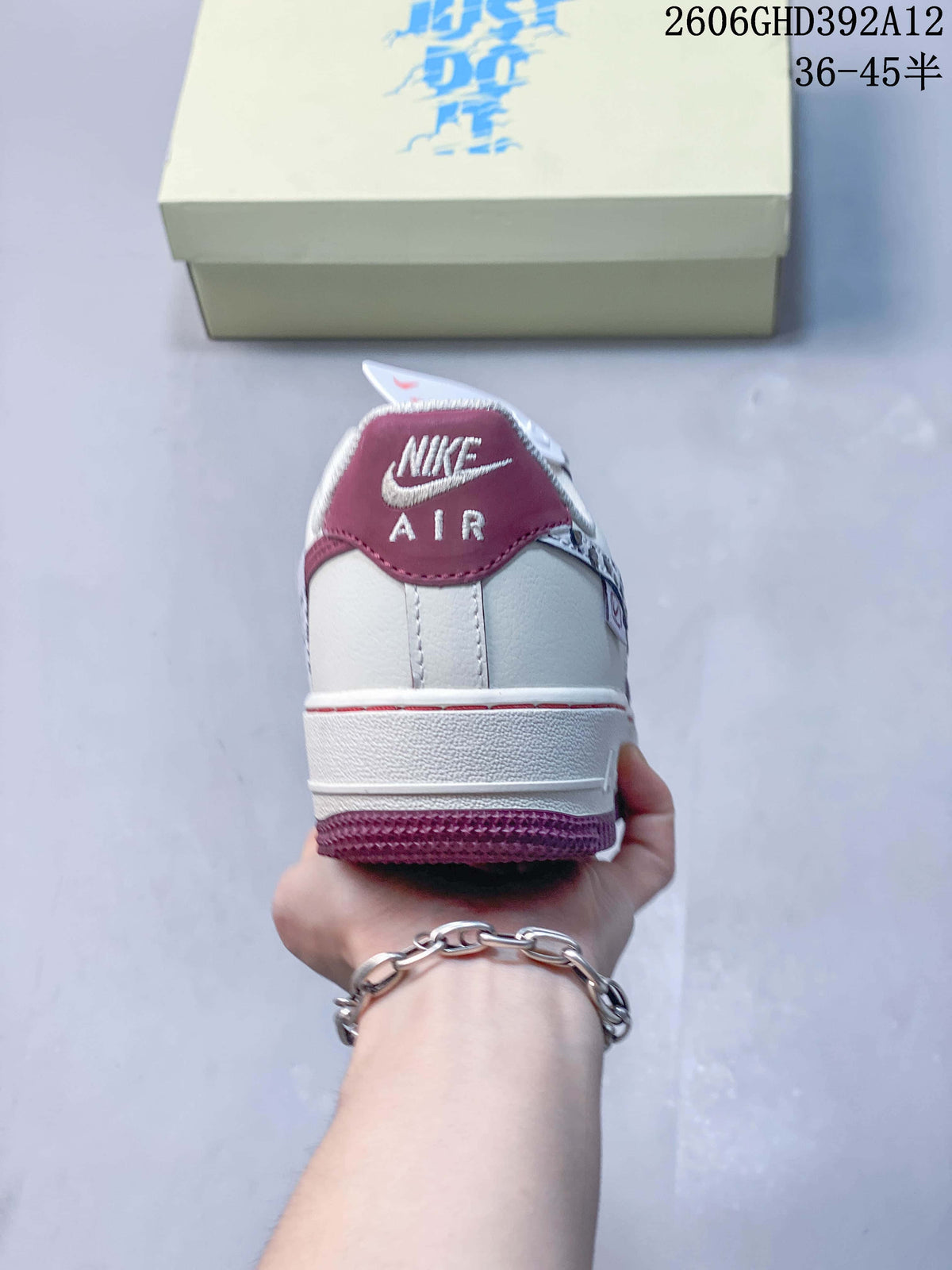 Rear view showing burgundy heel detail and off-white upper