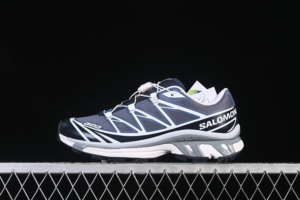 Side view of navy, gray, and white Salomon XT-6 GTX shoes