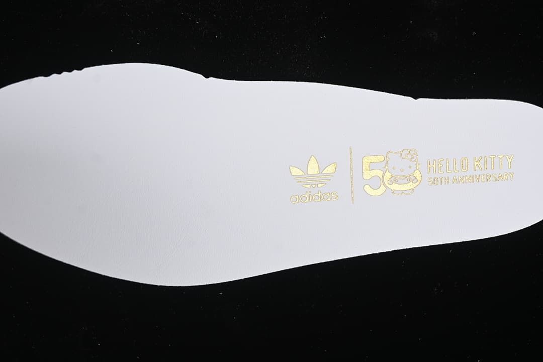 White insole printed with Adidas and Hello Kitty 50th anniversary branding.