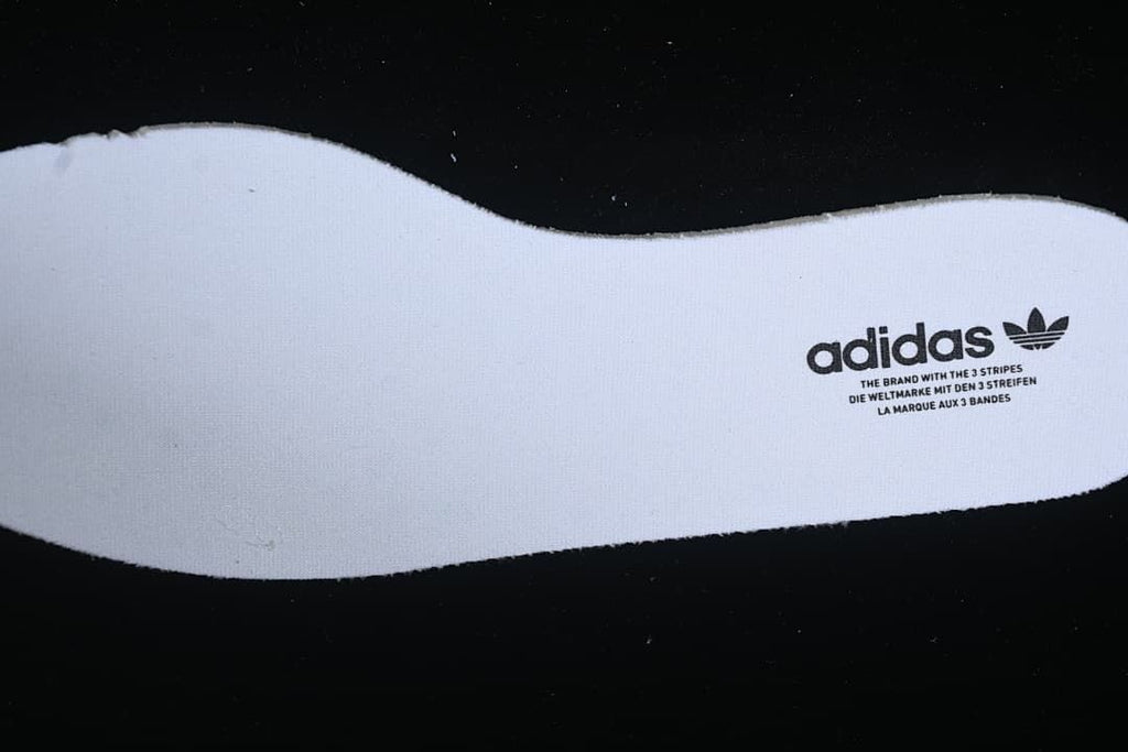Close-up of an insole printed with adidas branding