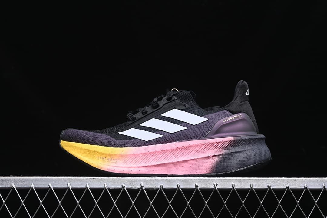 Side view of a black and purple adidas Ultraboost 5X with white stripes and a pink-to-yellow midsole.