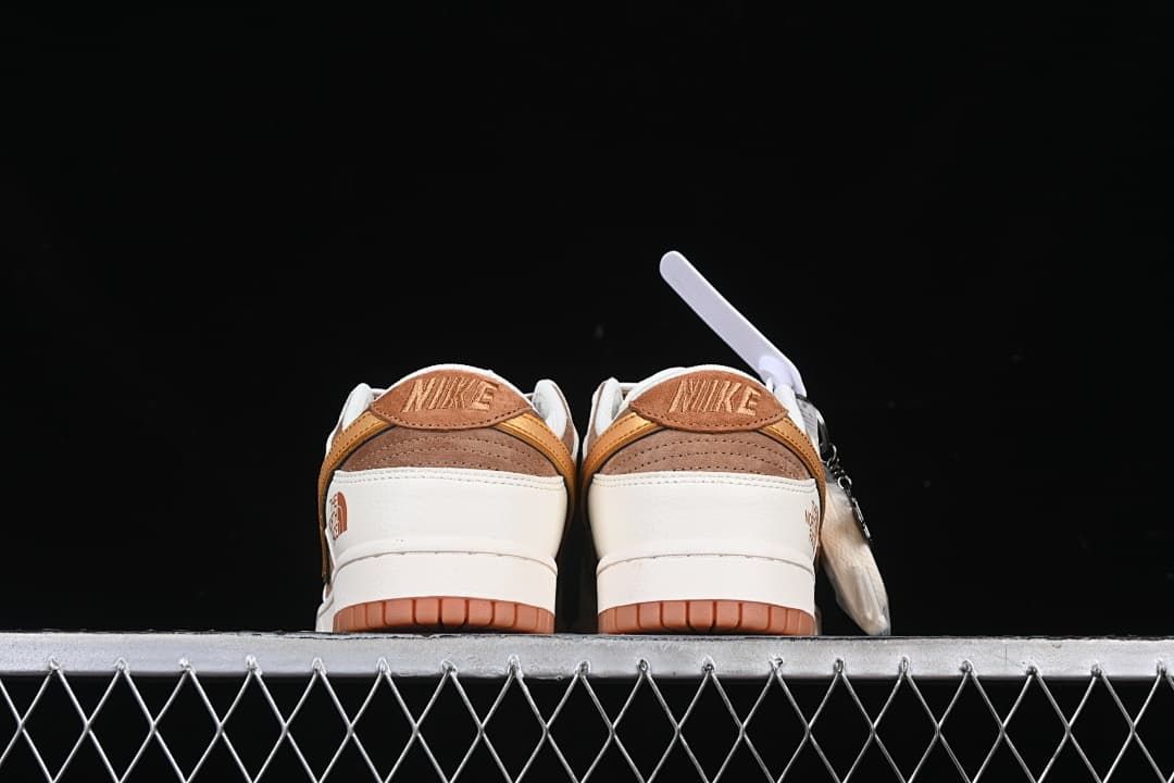 Rear view of both sneakers with brown heel panels and gum-colored outsoles