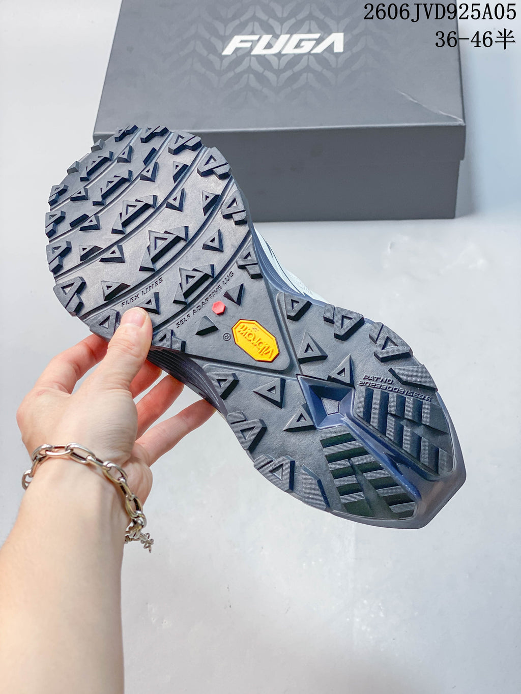 Close-up of the shoe outsole showing its pronounced tread and Vibram marking.
