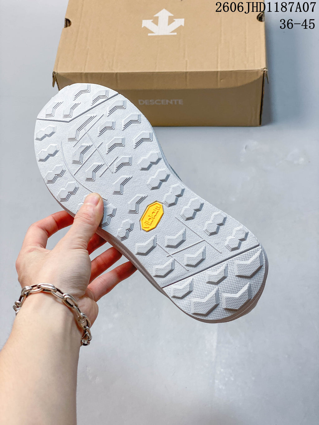Close view of the patterned outsole with a small yellow insert.
