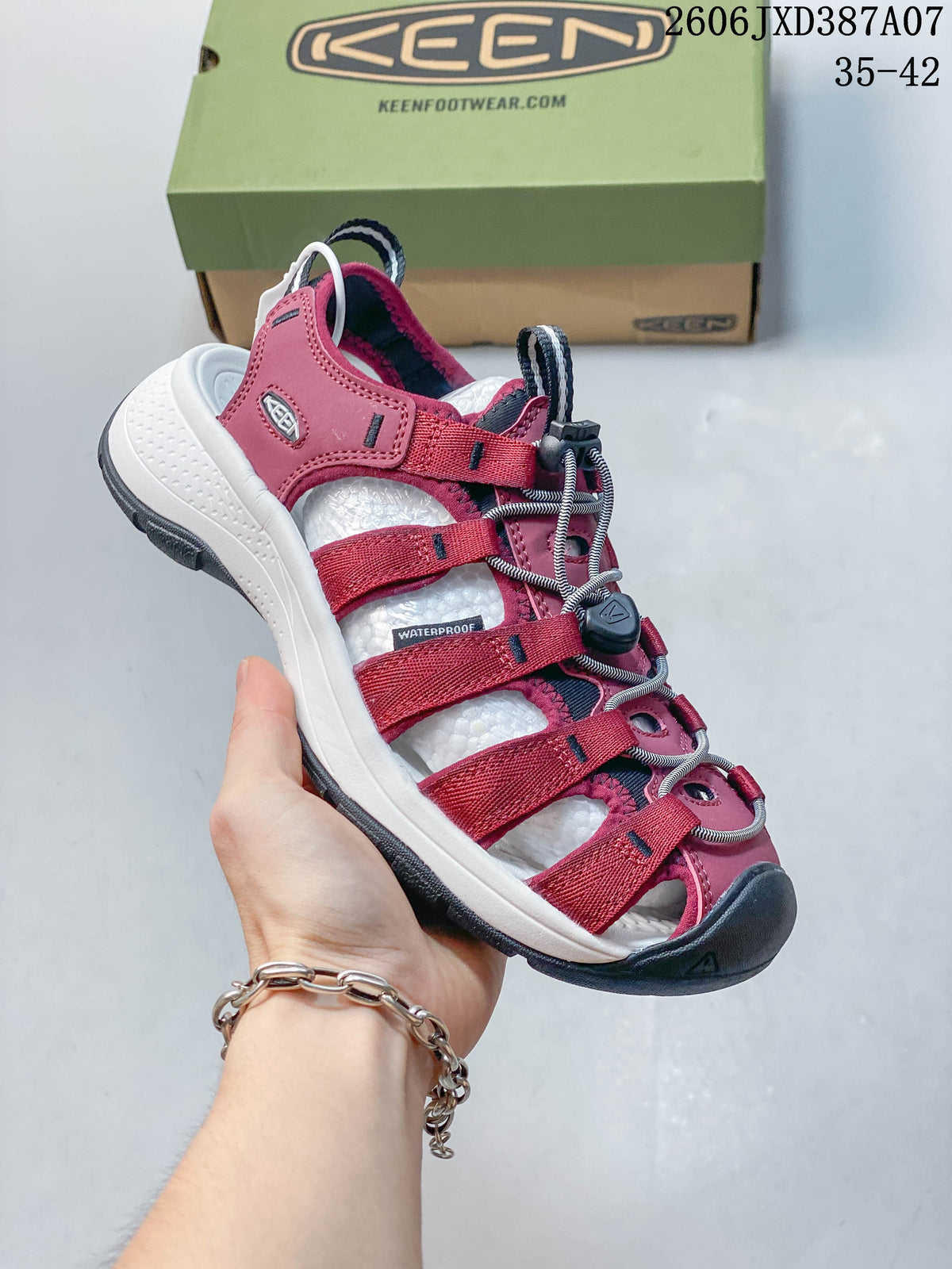 Angled side view of the berry sandal with a white midsole and dark outsole.