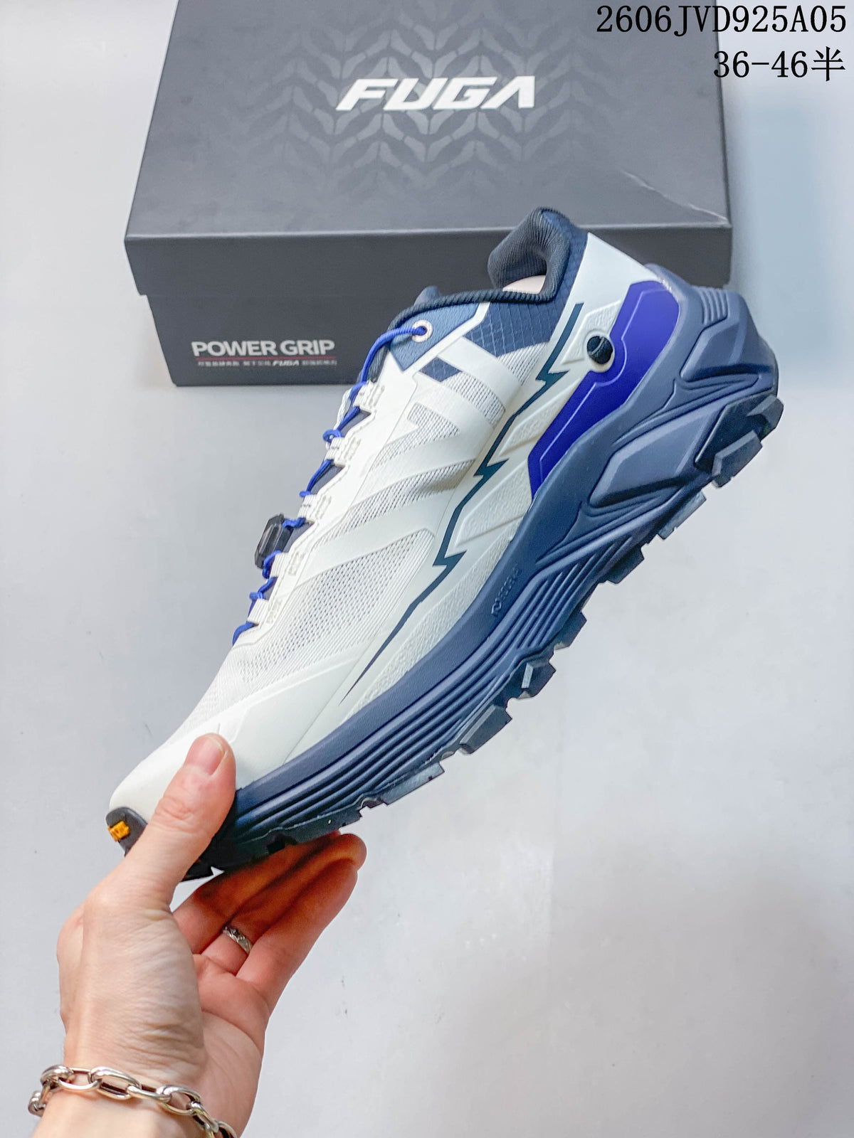 Side profile of the white and blue shoe with its dial-adjustment lacing system.