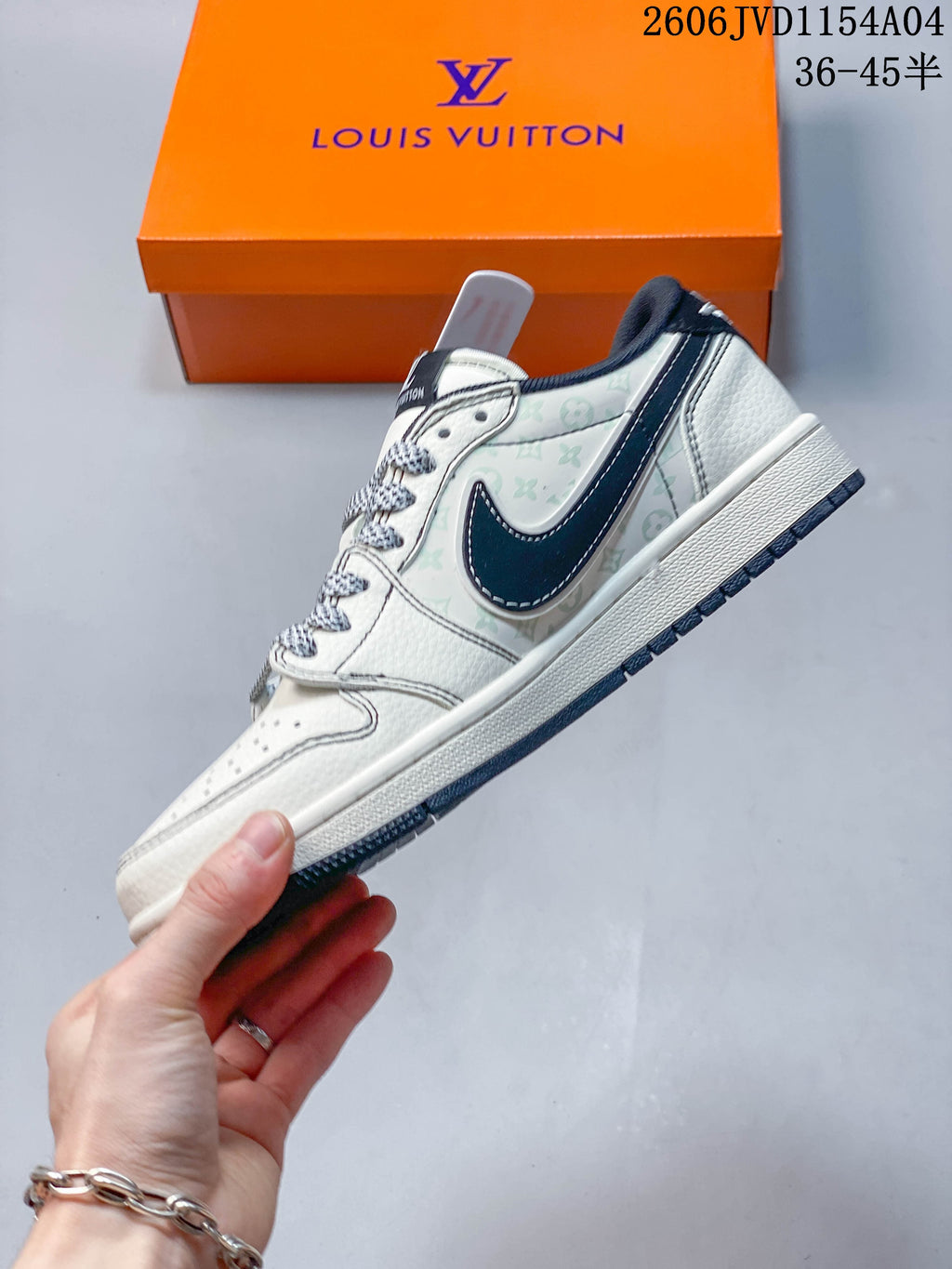 Side profile of the off-white sneaker with pale patterned panels, navy swoosh-shaped overlay and white midsole.