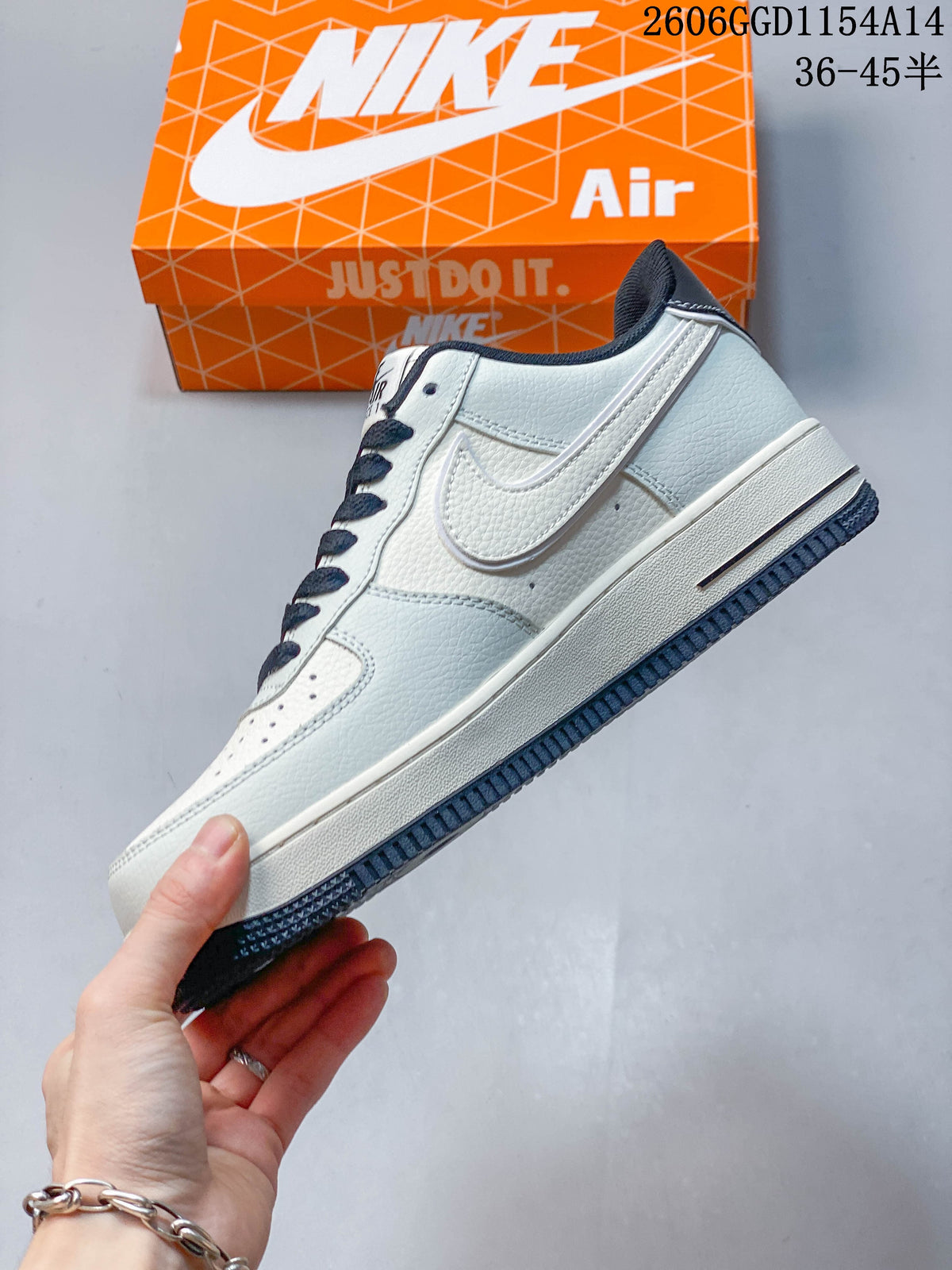 Side profile of a cream Nike Air Force 1 with navy Swoosh and outsole accents