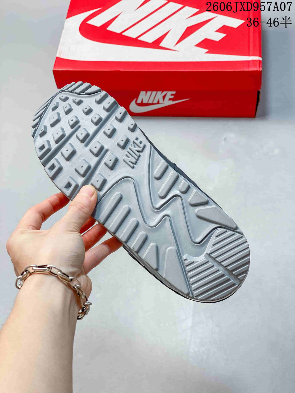 Close-up of the gray patterned outsole of a Nike Air Max 90 sneaker.