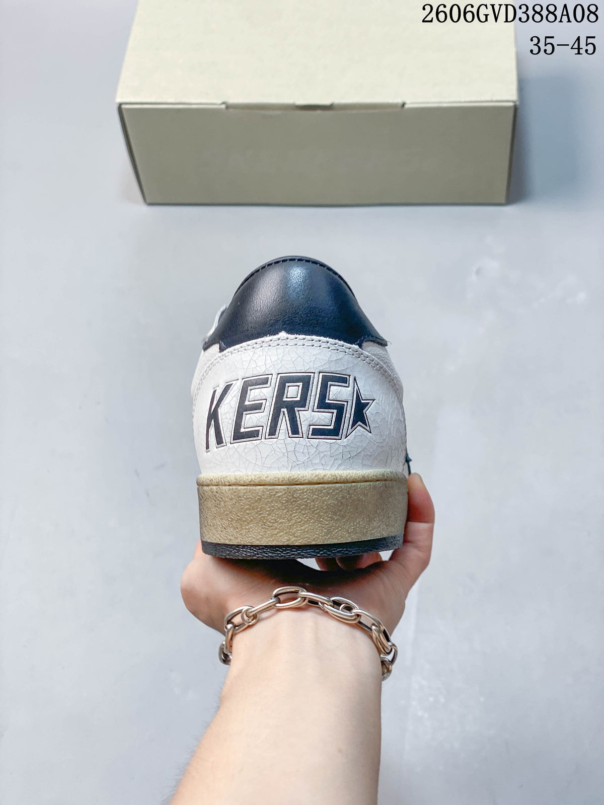 Rear view of the sneaker with navy heel detail and distressed-look sole
