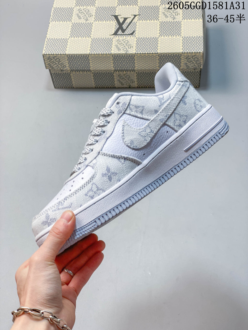 Side view of a white and grey Nike low-top sneaker with patterned overlays