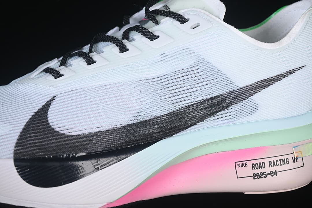 Close-up of the black Swoosh, white upper, and colored midsole accents
